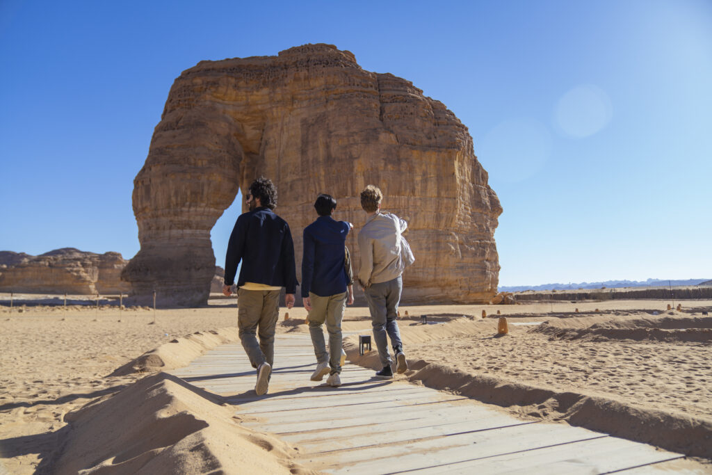 A group of men walking on a footpath towards Elephant Rock