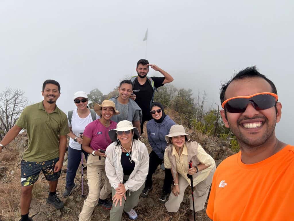 Group of diverse hikers enjoying outdoor adventure on a mountain trail.