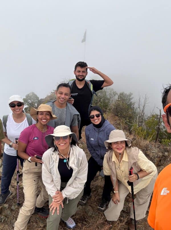 Group of diverse hikers enjoying outdoor adventure on a mountain trail.